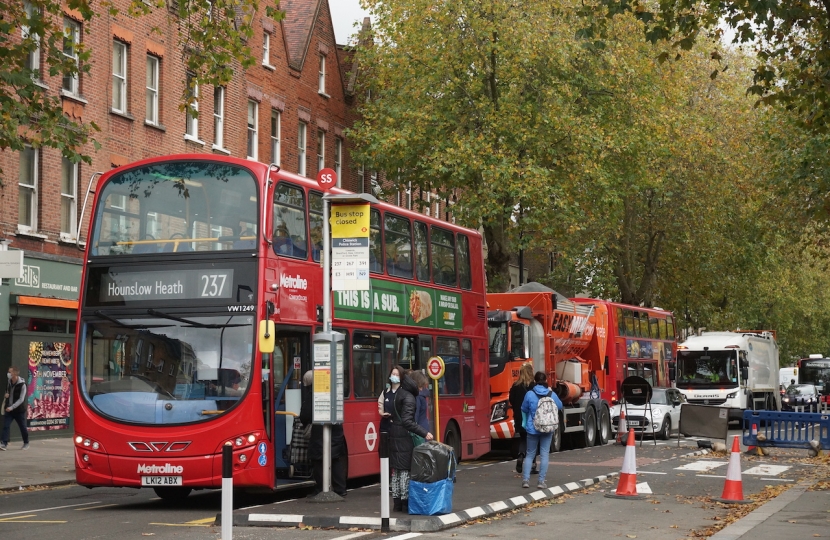 Buses and lorries stuck in gridlock at a floating bus island on Chiswick High Road