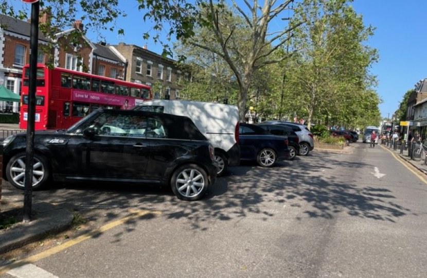 Car park seen from the west, a bus in the background and the George IV pub sign in the distance