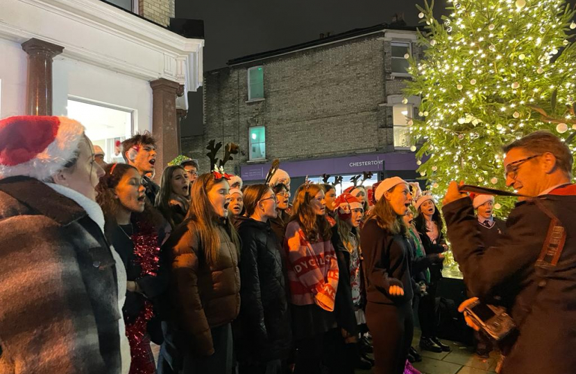 Chiswick School students singing The Twelve Days of Christmas next to the beautiful just-lit Christmas tree 