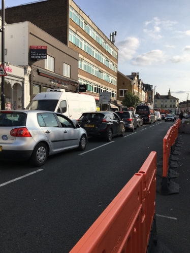 Turnham Green Terraced with traffic and bollards in September 2020