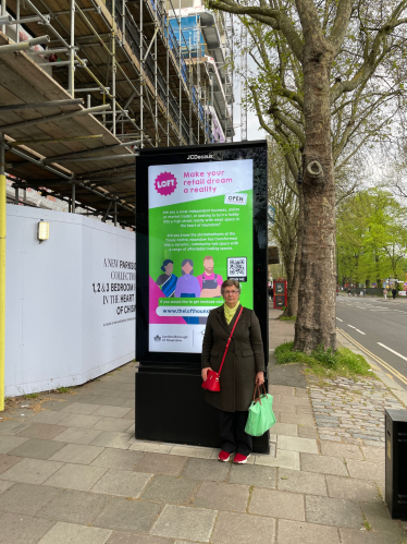 Cllr Biddolph standing in front of an existing hoarding showing its enormous scale. It is twice her height and more than twice her width (and she's podgy!). 