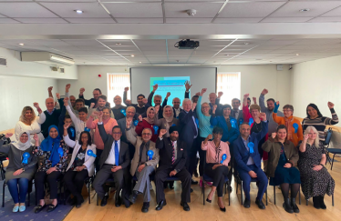 Candidates raising their hands and smiling as we launch our manifesto