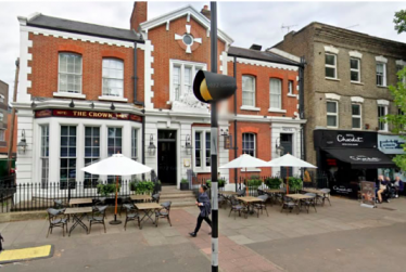 Photo of The Crown at 210 Chiswick High Road showing its outside tables and chairs