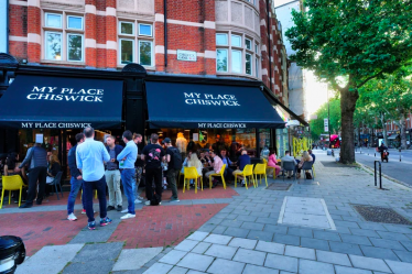 Front of My Place showing its awnings and people sitting at outdoor tables